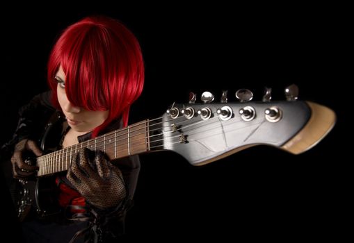 Attractive girl with guitar, selective focus on fingers, high angle view 