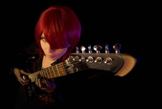 Sexy girl with guitar, selective focus on face, high angle view 