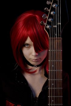 Sexy vampire girl with guitar, focus on face 