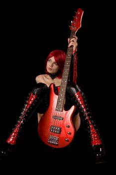 Fetish model with bass guitar, isolated on black background 