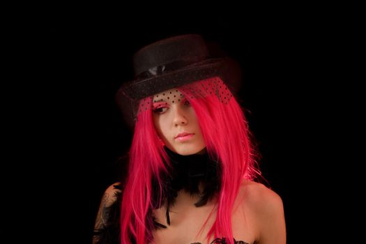 Upset girl with pink hair and make-up, isolated on black background 