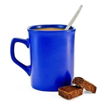 Coffee with milk, a silver spoon in a blue mug, two slices of porous brown chocolate isolated on white background