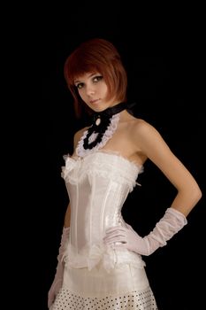 Attractive girl in white bridal corset, isolated on black background 