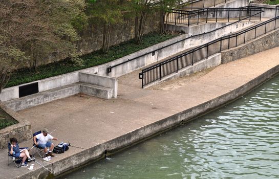 Waco couple fishes on the bank background