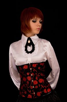 Romantic girl in white blouse and corset, isolated on black background 