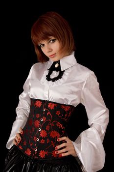 Beautiful girl in white silk shirt and corset, isolated on black background 