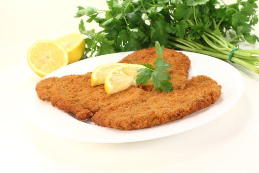 roasted wiener schnitzel with lemon slices and parsley