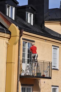 Carpenter puts a last hand on the new balcony doors.