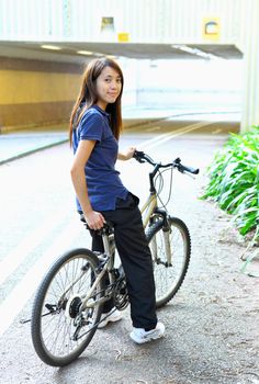 young woman riding bicycle in city