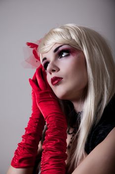 Portrait of blond cabaret woman with red glitter makeup 