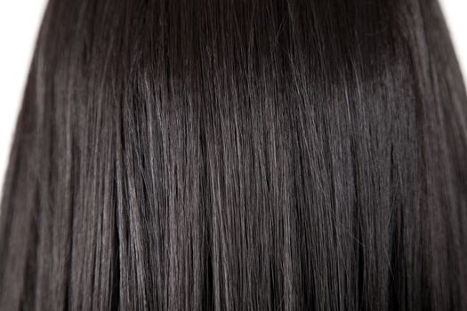 Texture of black shiny healthy straight hair, soft focus 