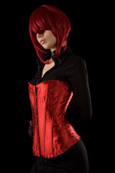 Sensual girl in red glamour corset, isolated on black background  