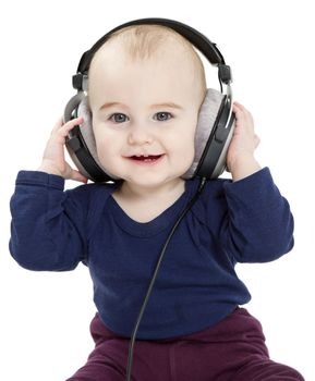 toddler with earphones isolated on white background. Vertical image