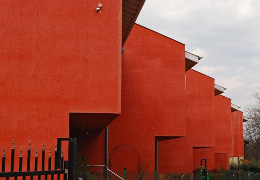 Red painted family houses side-ward view in perspective