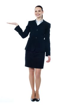 Full length of beautiful business woman showing copyspace up over white background