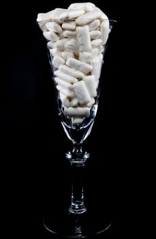 Picture of a bunch of white gums in a wine glass