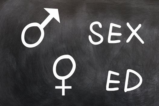 Sex education with gender symbols written with chalk on a blackboard