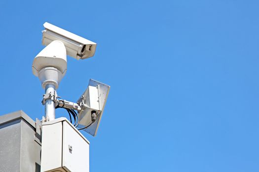 isolated Surveillance Security Camera or CCTV on blue sky