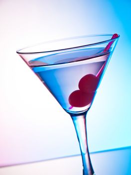Glass of martini cocktail with cherries