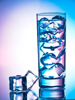 Glass of clear cocktail filled with ice cubes