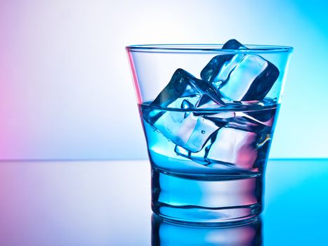 Glass of clear drink on the rocks