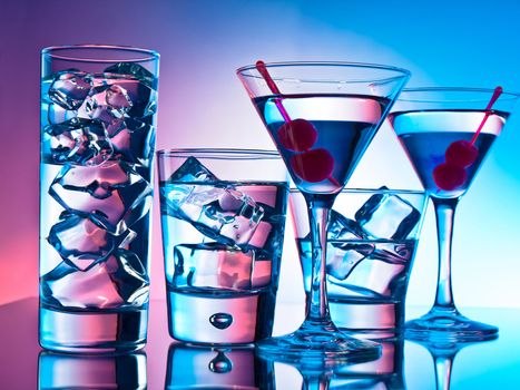 Variety of cocktails on pink and blue background