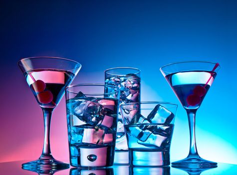 Variety of cocktails on pink and blue background