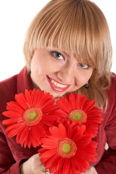 A smiling green-eyed girl with red flowers