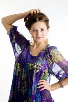 An image of a young smiling girl in a violet dress