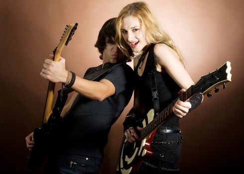 An image of girl and boy with guitars
