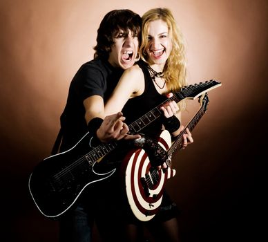 An image of a girl and a boy with guitars