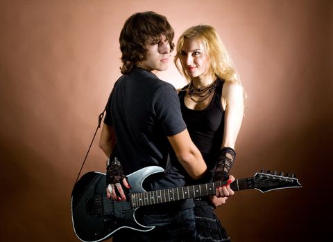 An image of a man and a woman with guitar