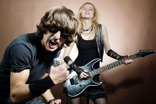 Rock band:  man and woman during concert.