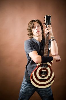 An image of young man with striped guitar