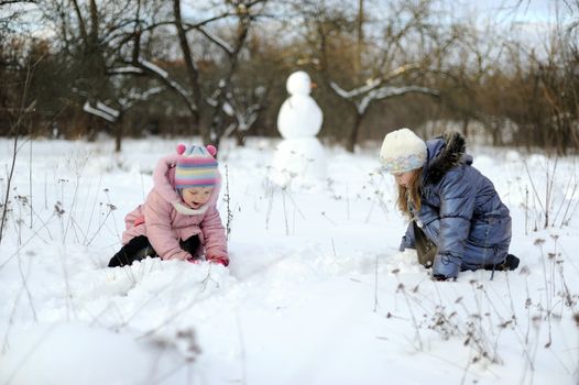 An image of a little girls playing snowballs