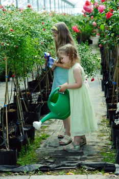 An image of two little sisters in a greenhouse