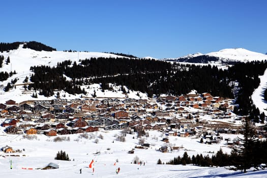 alpine village with snow in winter in France