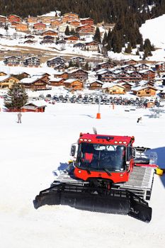 alpine village in winter with snowplow