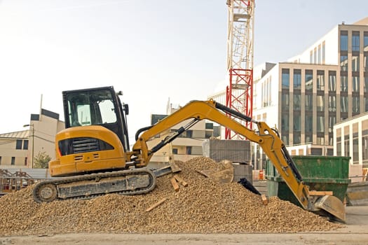 bulldozer waiting on piles of gravel