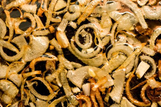 Close-up of Fried onion and oil on the  pan