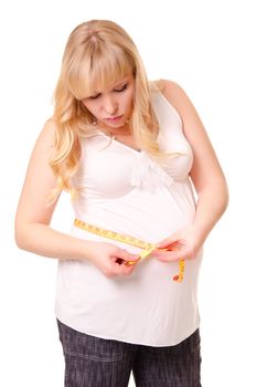 Pregnant woman measuring her belly isolated on white