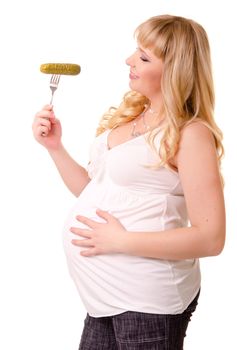 Pregnant woman with preserved cucumber on a fork isolated on white