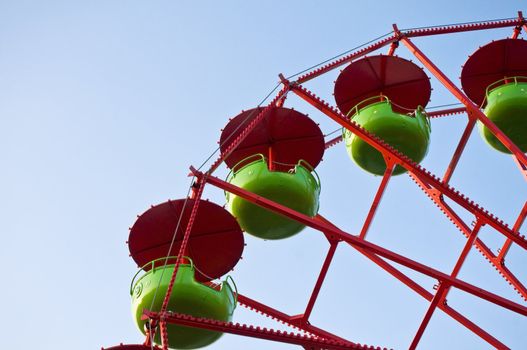 Detail of a green and red Ferris Wheel