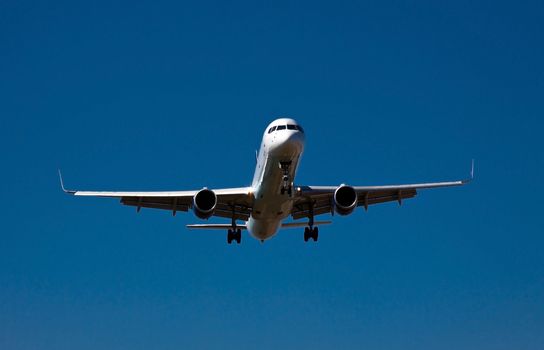 photograph of an airplane few seconds before landing 