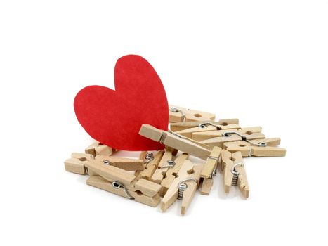 Red heart on many wooden pins with one wooden pin pinch it on white background