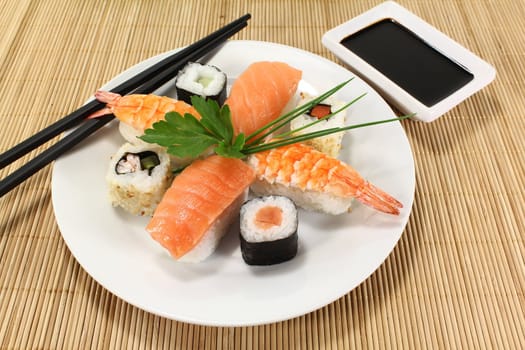 variety of sushi with parsley and chives