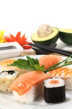 variety of sushi with parsley and chives