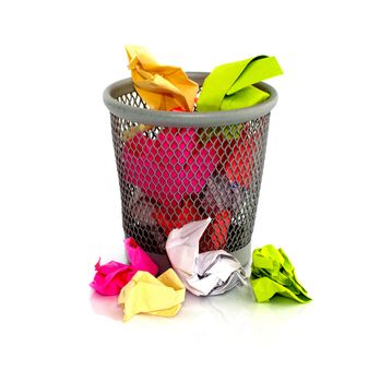 colored paper in  waste basket on isolated white