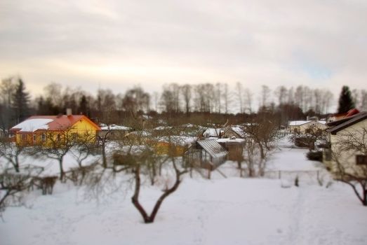 Winter. Cottage village with tilt shift lens effect.