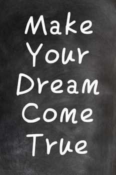 Make your dream come true - text written with chalk on a blackboard